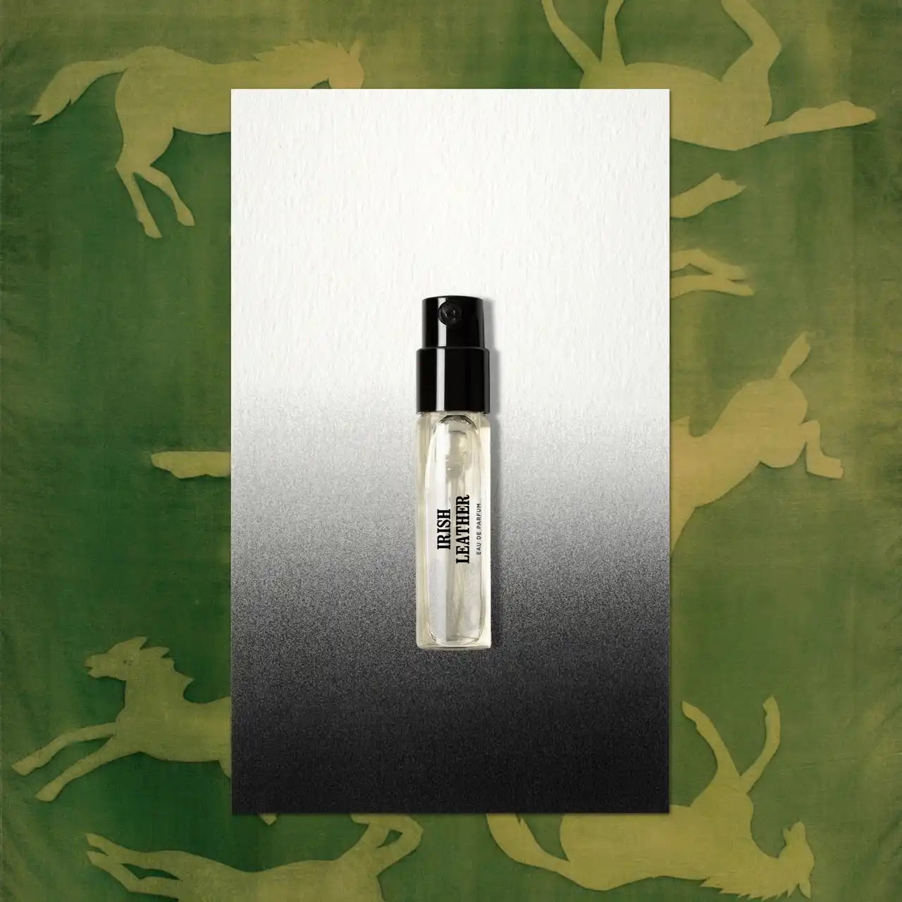 Clear perfume sample with black cap.