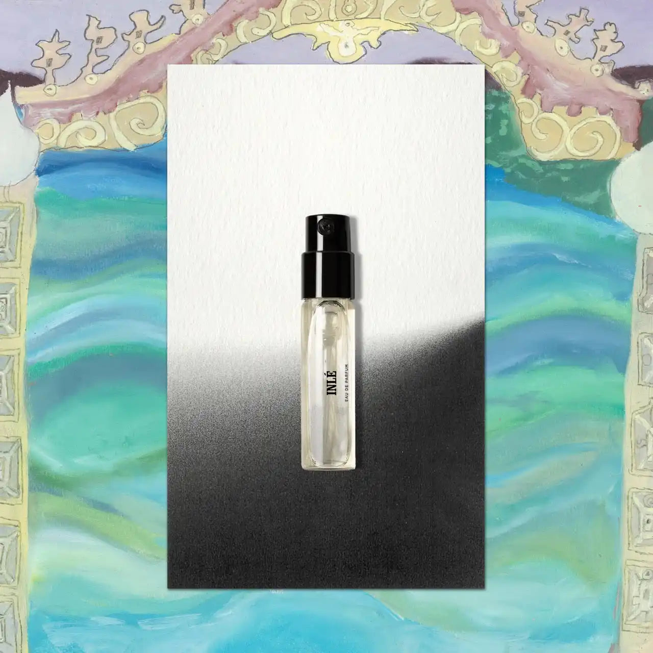 Clear perfume sample with black cap.