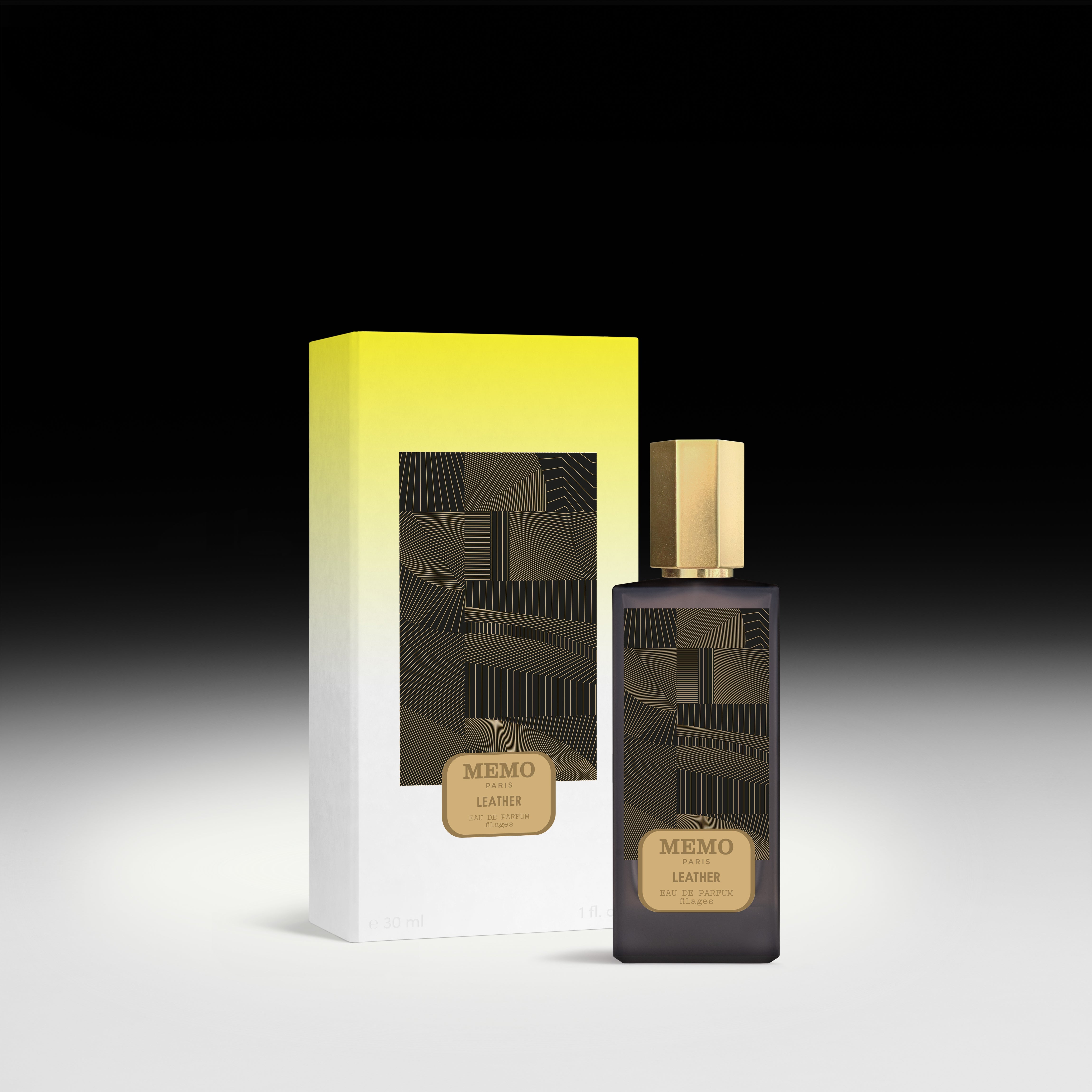 Dark glass bottle with gold cap and geometric label of memo paris essences filages leather fragrance eau
