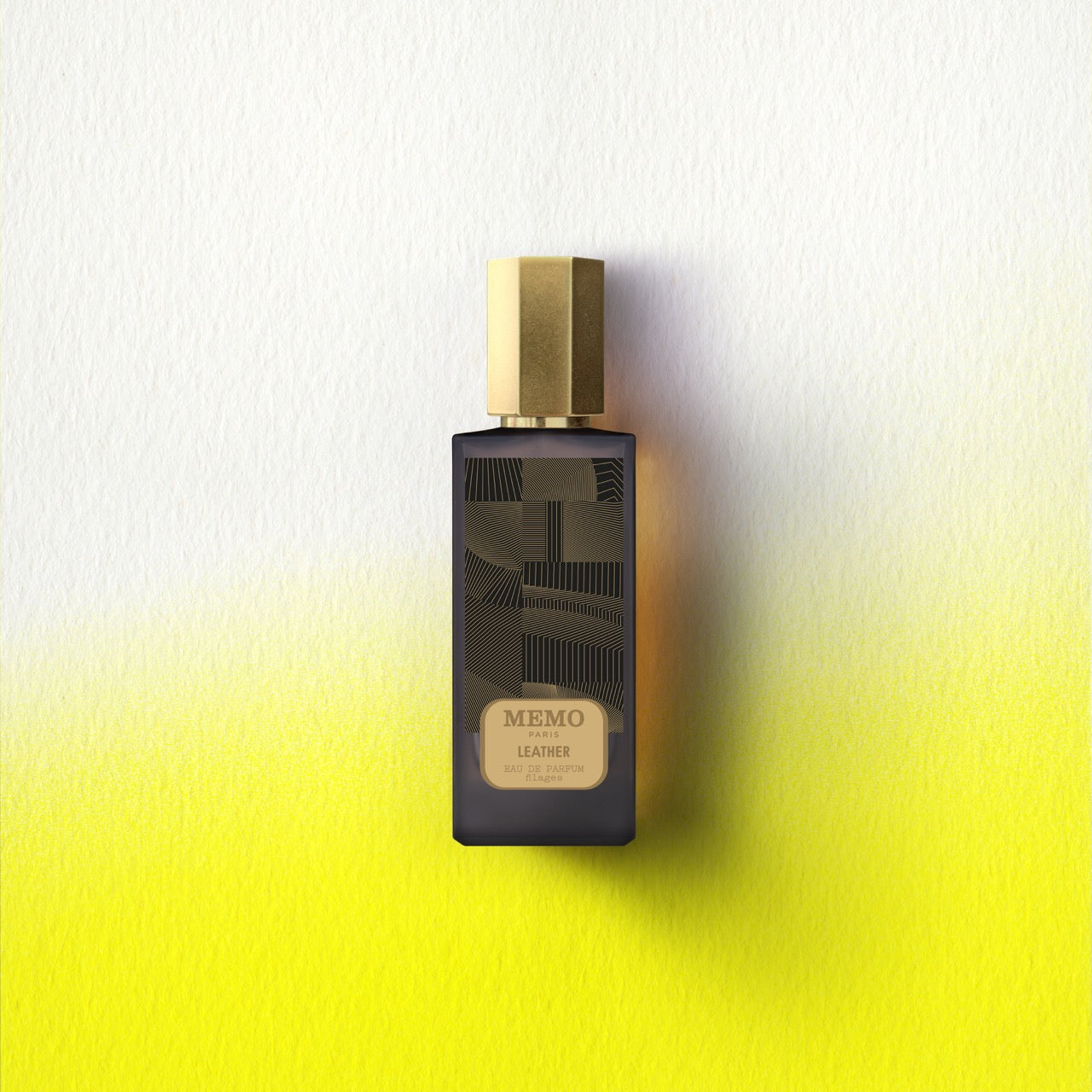 Dark glass bottle with gold cap and geometric line art label from memo paris essences filages filages eau collection
